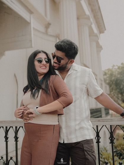 A happy, laughing embrace on the balcony. This shot is full of genuine emotion and connection.