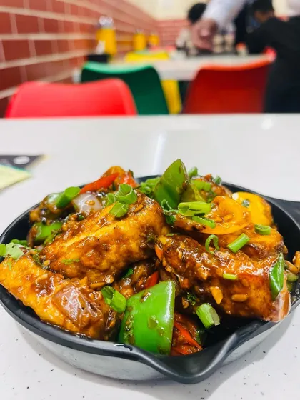 My Paneer Chilli Dry is a classic starter that's always a hit. Soft paneer cubes are tossed in a spicy sauce with onions and bell peppers.