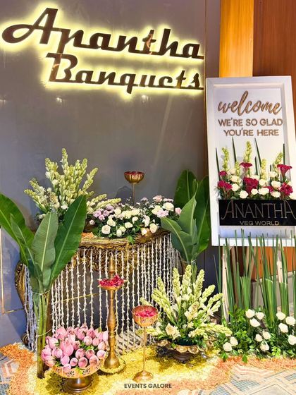 A grand floral and lighting installation for Anantha Banquets. This setup combines traditional elements like marigolds with modern lighting and lush greenery for a rich, festive look.
