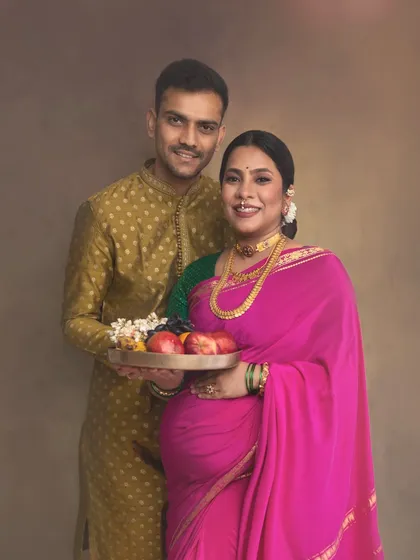 A traditional pose where the couple holds a platter of fruits, symbolizing prosperity and blessings for the baby. It’s a culturally significant moment captured in my signature painterly style.