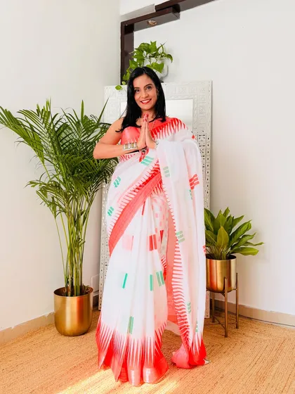 This white cotton linen saree with a geometric tricolor pattern is modern and chic. It's a stylish way to celebrate Independence Day or Republic Day.