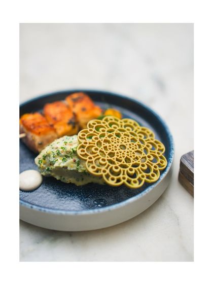 A beautiful plate from a flying buffet, featuring Charred Seekh Kebab Polpettinis and Amritsari Salmon Aburi, showcasing the variety and artistry of the small plates format.