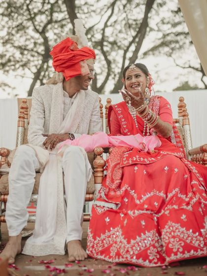 Laughter during the ceremony. We believe in capturing the real, unposed moments, and this image of the couple sharing a laugh during their wedding rituals is a perfect example of the joy we seek in our work.