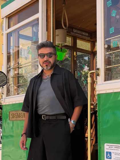 A closer shot of my Sofia outfit, showing the layering of the black shirt over the grey tee and the simple silver chain accessory.