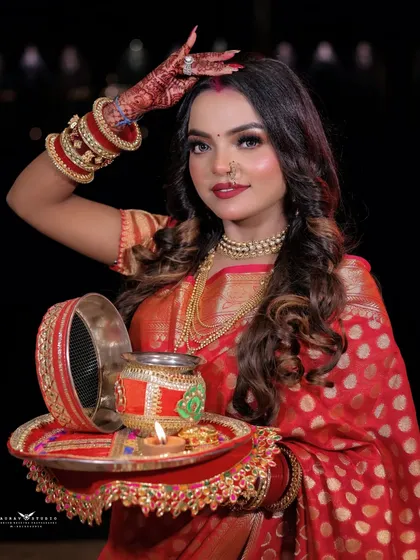 The model holds a traditional Karwa Chauth thali, creating a perfect shot for the occasion.