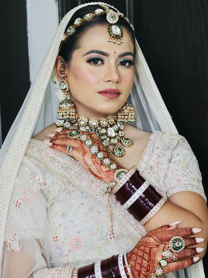 A confident pose, showing the side profile and the stunning earrings.