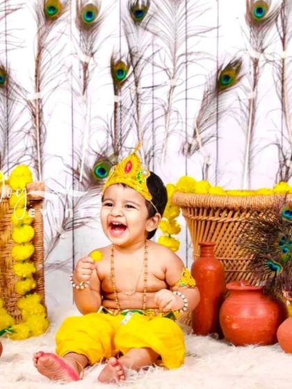 The playful spirit of childhood shines in our Little Krishna themed photoshoot. We create a vibrant and authentic setting with peacock feathers, marigold garlands, and traditional clay pots, capturing your child's joyful laughter and divine charm.