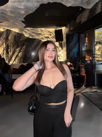 A full view of the black strapless top and pants, a versatile look for any night out.