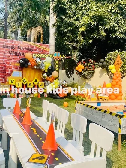 A wide view of the complete construction-themed party, showing our white tables, sandpit, and themed backdrops all working together to create an immersive environment.