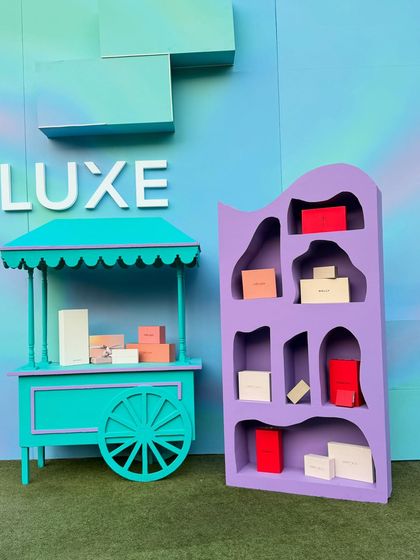 We designed multiple custom display units for the Ajio Luxe activation, including this turquoise cart and a unique purple shelving unit. This approach allows for creative product merchandising that breaks away from standard displays.