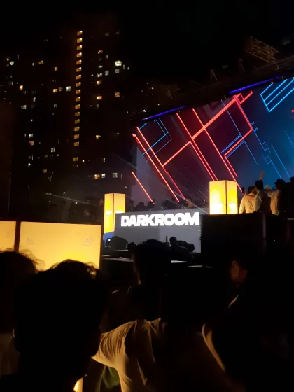 The view from the crowd at Darkroom, with the DJ booth and stunning visuals creating an immersive techno experience.