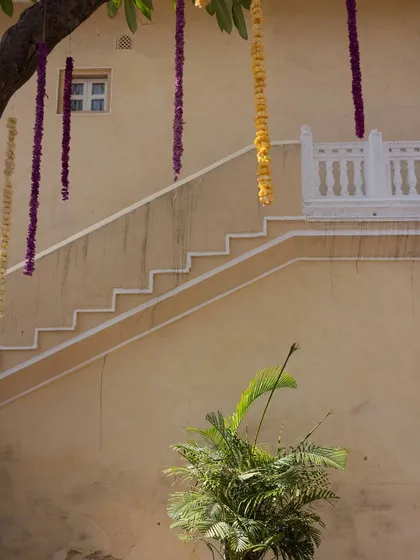 Simple yet elegant decor details, like these hanging floral strings, add a touch of color and festivity to the palace walls.