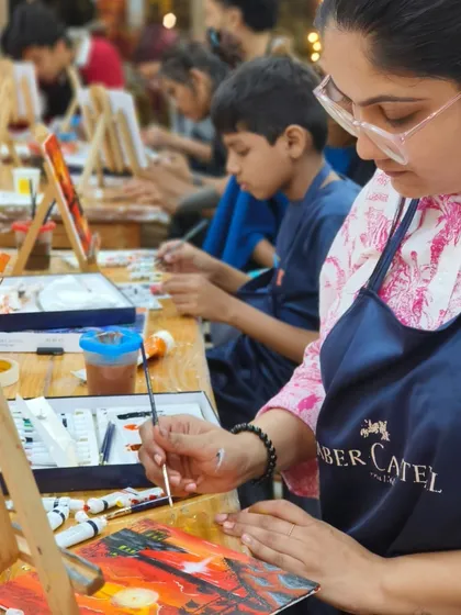 An overhead view of our bustling workshop. You can see the concentration and enjoyment as participants bring their individual canvases to life.