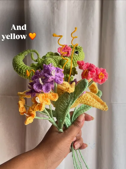 Building the Rapunzel bouquet, one flower at a time. This image shows the addition of yellow and purple flowers to the arrangement, creating that signature color palette.