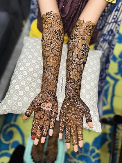 The full view of this bridal floral design. The patterns are a beautiful mix of bold flowers and delicate leaves, covering the arms completely.