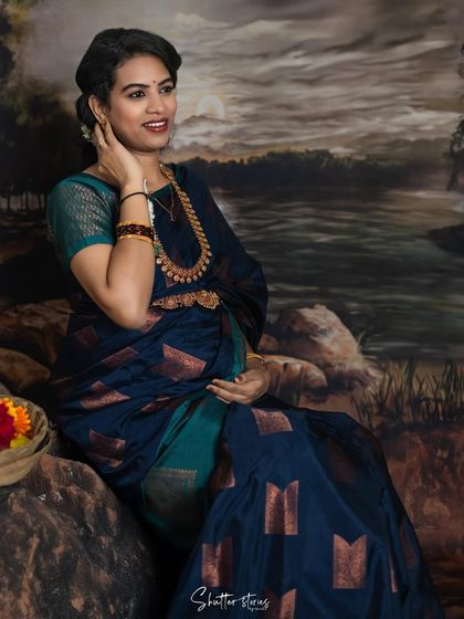 Another angle from the simple traditional setup, capturing a different expression and the beautiful details of the saree and jewelry.