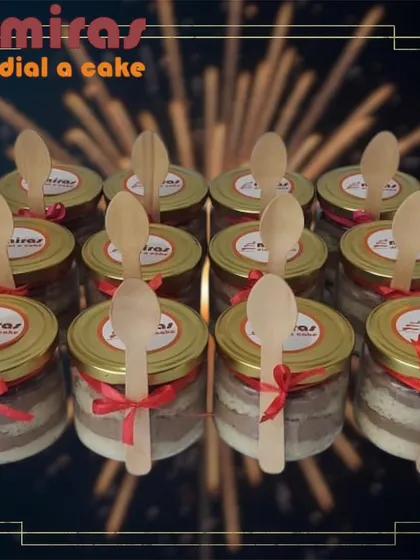 My cake jars are a popular gifting option, perfect for party favors or corporate giveaways. This photo shows a batch of my layered cakes, each sealed in a glass jar with a wooden spoon attached, ready for easy enjoyment.