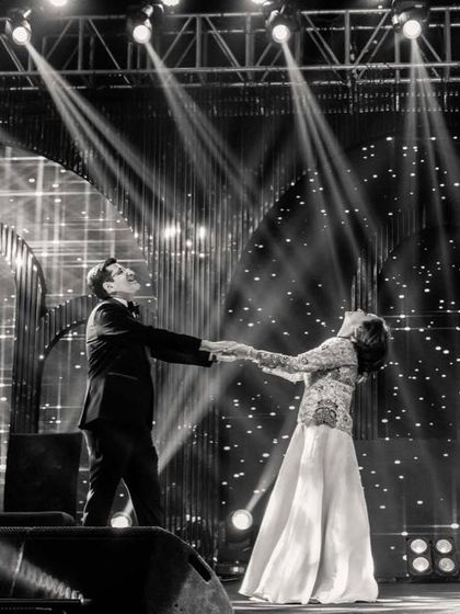 A classic black and white shot of the bride's parents during their romantic dance, looking timeless and elegant.