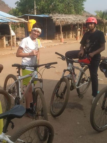 A group of friends with their mountain bikes takes a break during the Aqua Sports Camp at Vani Vilas Sagara.