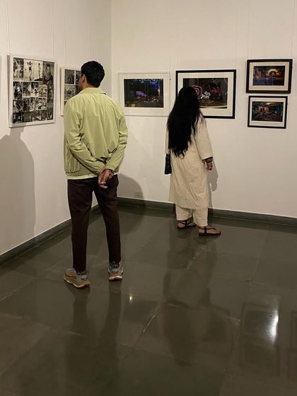 Visitors viewing a collage of black and white photographs from the 'SOUTHERN STARS' show. The exhibition is a deep dive into the visual culture of South Indian cinema.