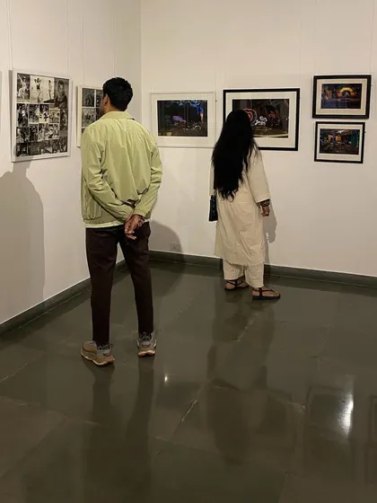 Visitors looking at a collection of black and white film stills.