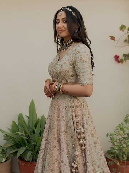 Another angle of this timeless look. Her hair is left down in soft waves, and the makeup is minimal and fresh.