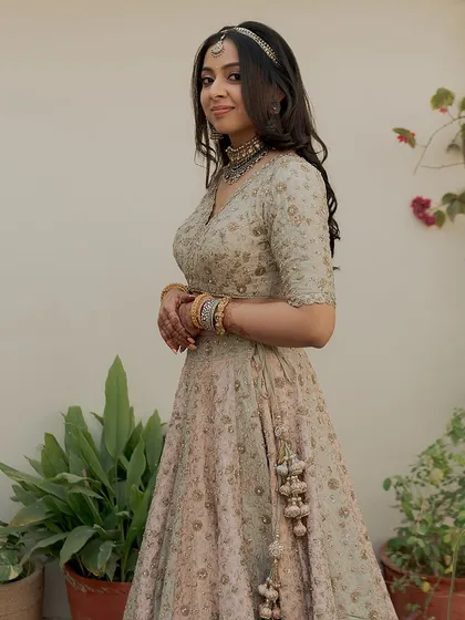 Another angle of this timeless look. Her hair is left down in soft waves, and the makeup is minimal and fresh.