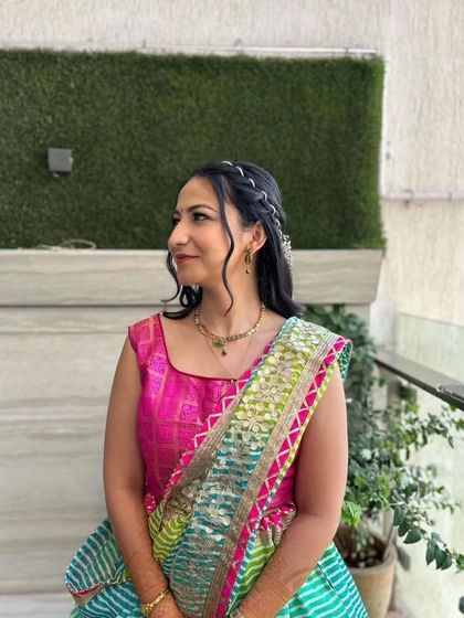 A side profile showing the soft curls and braided details of the hairstyle.