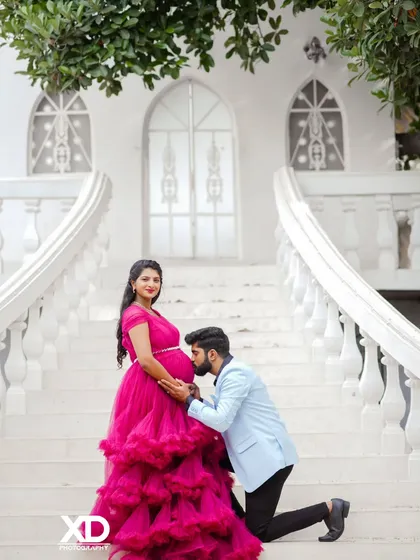 A fairytale moment for the parents-to-be. This shot, taken on a grand white staircase, combines a beautiful flowing gown and a tender pose to create a dramatic and romantic pregnancy portrait.