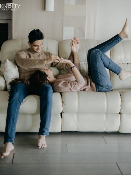 A playful, carefree moment on the couch. My goal is to make you feel so comfortable that you forget the camera is there, allowing your true personalities to shine.