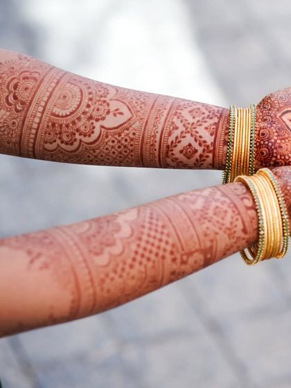 A beautiful shot of the mature henna stain on the arms, showing the intricate patterns in a lovely reddish-brown color.