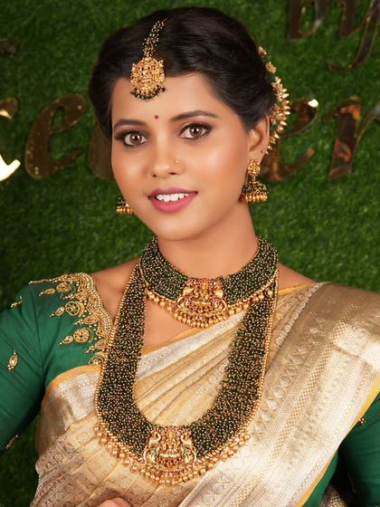 This bride has paired her green saree with a unique black-beaded temple jewellery set for a very elegant and different look.