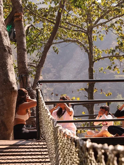 Participants practicing Nadi Shodhana pranayama, or alternate nostril breathing, during a retreat. This technique is fundamental for balancing the left and right hemispheres of the brain and calming the nervous system.