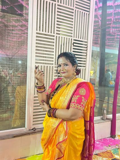 A happy client enjoying the wedding festivities in a bright yellow Nauvari. It’s all about celebrating in style.