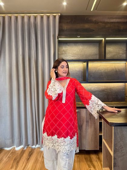 The clean V-neckline and minimal pearl borders on this red kurta create an elongated look. It’s a smart design choice that makes you appear taller and slimmer.