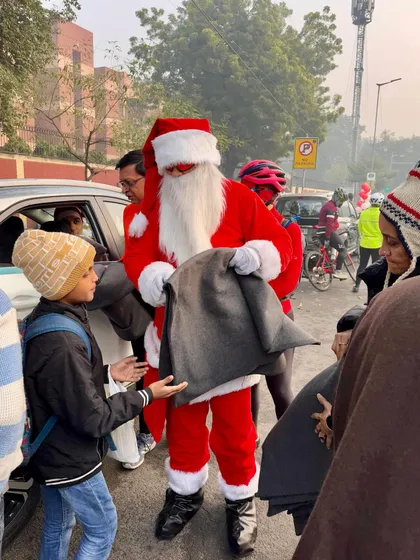 Another heartwarming moment of giving, as one of our Santas hands a blanket to a young boy.