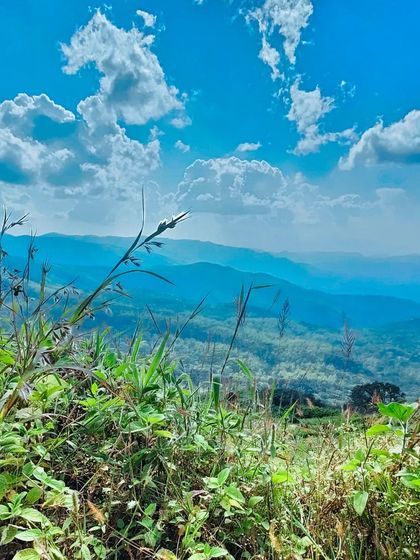 A beautiful capture of the blue sky and green hills on a clear day.