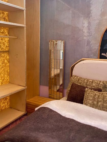 A view of the wardrobe and bed within the scale model. The back of the wardrobe is even lined with a textured material to simulate a real-world finish.