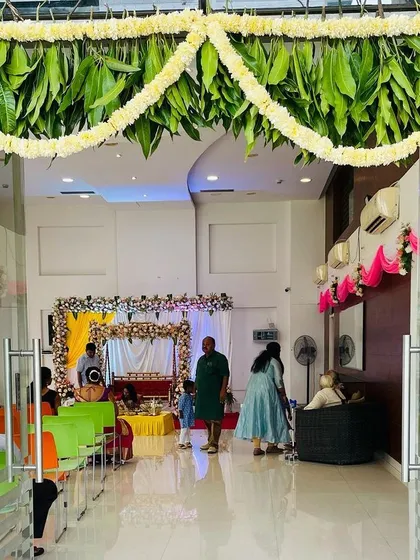 For a traditional housewarming ceremony, or griha pravesh, I designed this welcoming entrance. It uses auspicious elements like fresh mango leaf and marigold flower garlands to create a festive and culturally rich entryway.