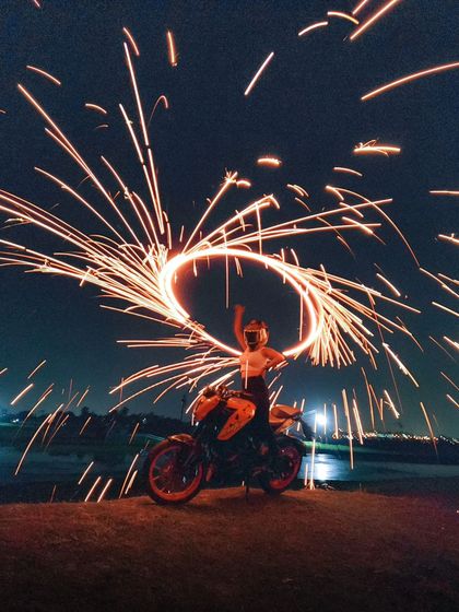 A dynamic shot from the steel wool tutorial, showing the model's pose and the energy of the spinning fire.