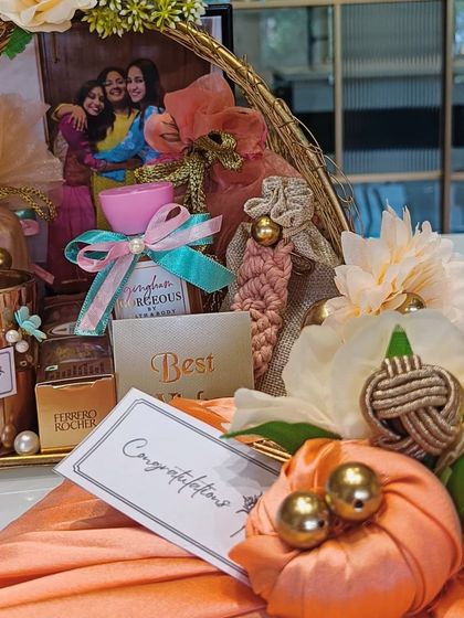 A detailed shot showing the 'Congratulations' card alongside the curated gift basket, ready to be presented to the happy couple.