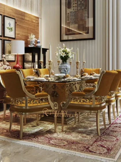 An opulent dining setting where timeless elegance meets the art of fine dining. The custom-designed chairs with gold leaf detailing and rich upholstery sit beautifully against a backdrop of wood and fluted wall panels.