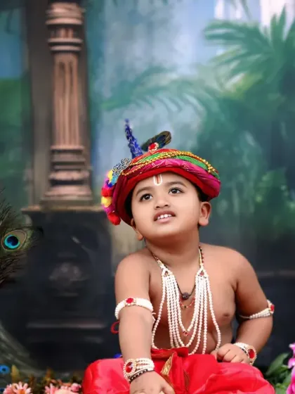 A thoughtful pose from our little Krishna, looking up as if contemplating some divine mischief.