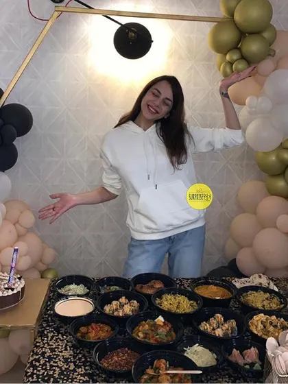 A birthday celebration at home, complete with a modern balloon arrangement in black, white, and olive green. This shows how we can transform any space for a special occasion.