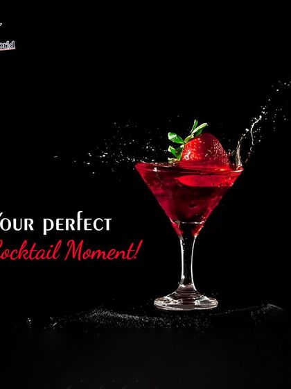 A perfect cocktail moment captured as a fresh strawberry splashes into a classic martini glass. This dynamic shot highlights the fresh ingredients and excitement we bring to our drinks.