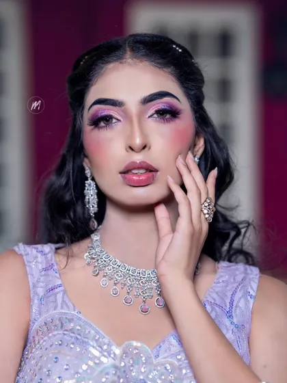 A close-up of the dramatic purple eye makeup and glossy lips.