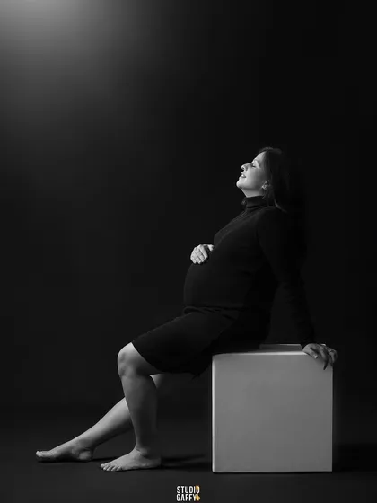A simple, elegant, and classic maternity portrait. Using dramatic lighting in the studio, I focused on creating a serene and contemplative mood, highlighting the beautiful silhouette of the mother-to-be against a dark backdrop.
