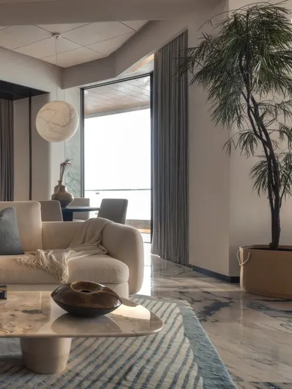 This living space at Palais Royale is designed as a tranquil sanctuary that balances calm minimalism with refined elegance. Bathed in soft, atmospheric lighting, the space evokes an intimate, almost meditative quality, perfect for quiet evenings.