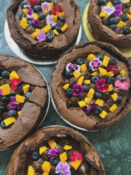 A top-down view of multiple flourless chocolate cakes ready for delivery. It makes me so happy to see this bestseller being a part of so many of your celebrations.