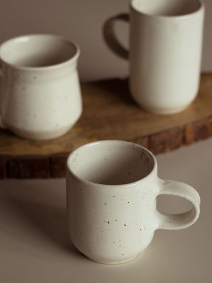 Simple, elegant, and perfectly imperfect. These speckled white mugs are a testament to the beauty of minimalist design.